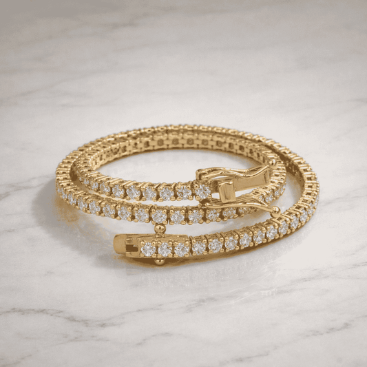 Gold bracelet with diamond accents on a marble surface