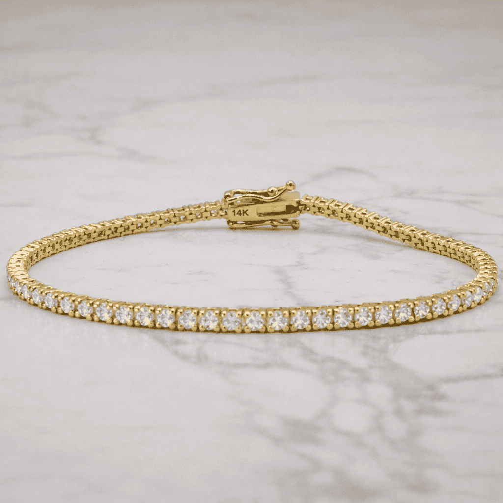 Gold bracelet with diamonds on a marble surface