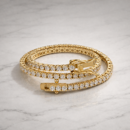 Gold bracelet with diamond accents on a marble surface