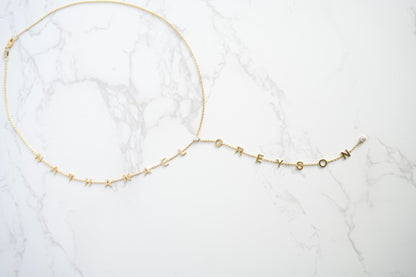 Gold necklace on a white marble surface